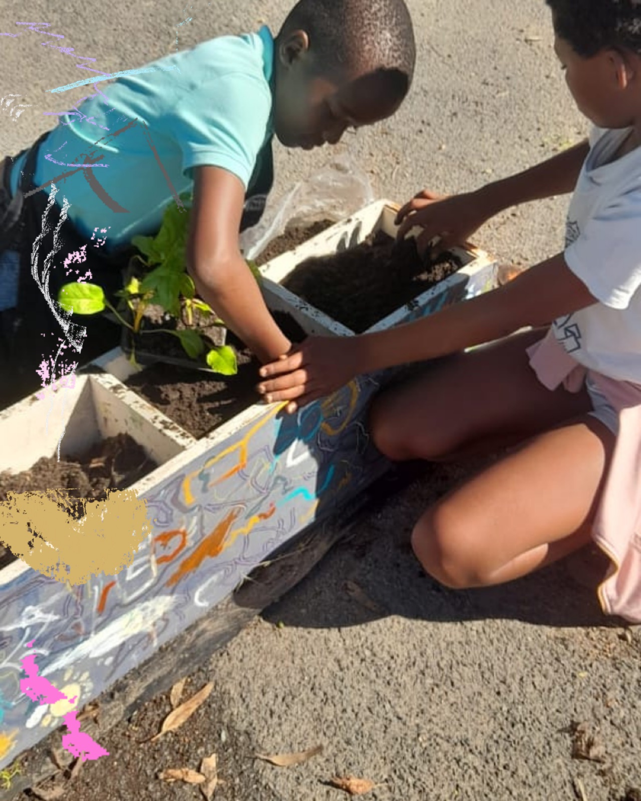 Children work together to plant in a garden bed