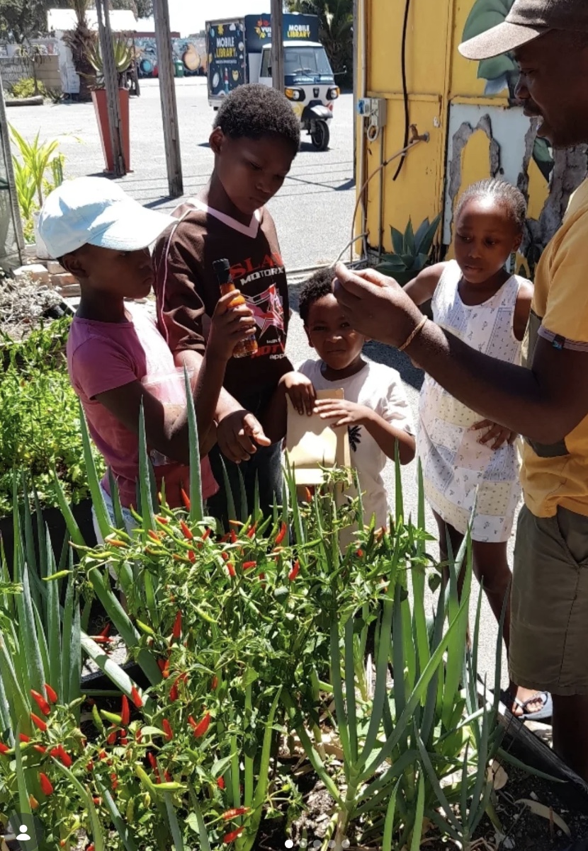 Children learning about plants and the garden with a local guide