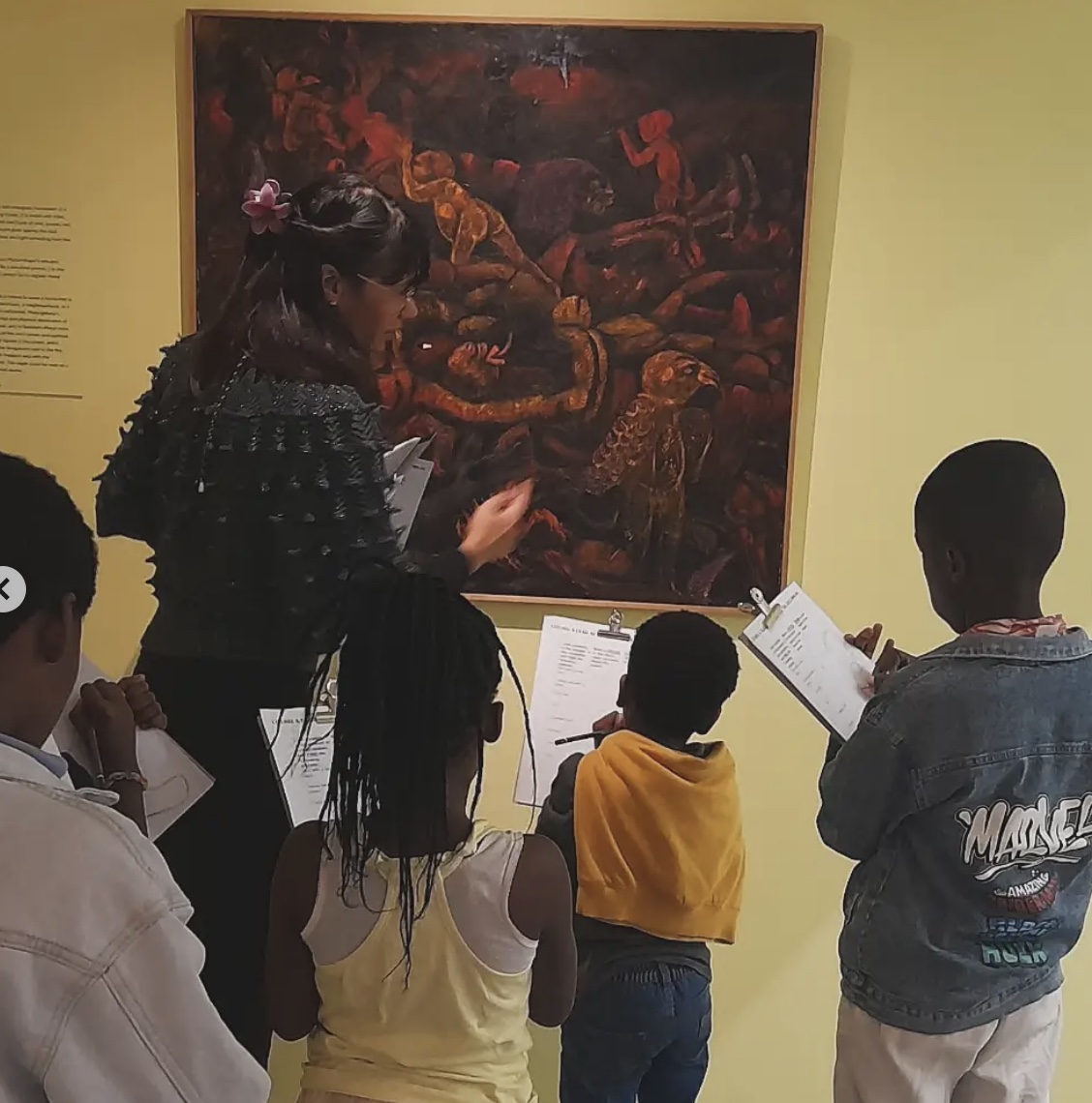 An educator discussing an artwork with the children